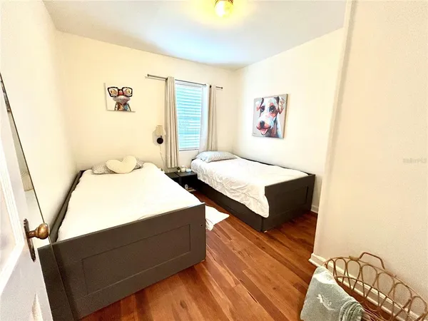 a bedroom with a bed and a night stand