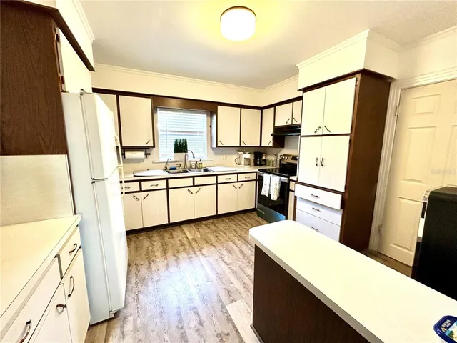 a kitchen with stainless steel appliances a sink and a refrigerator