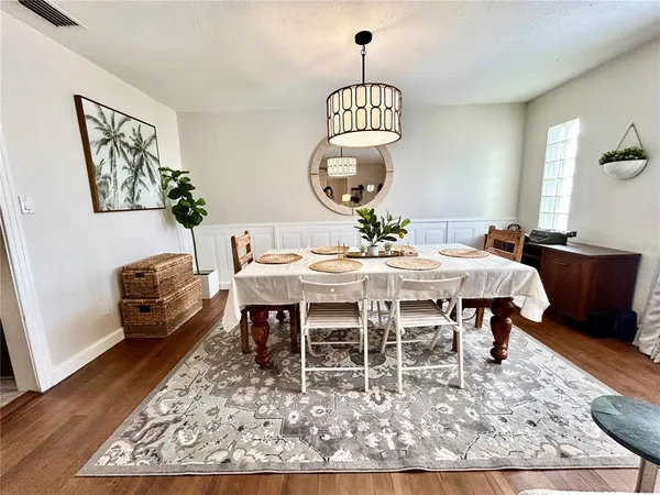 a view of a dining room with furniture window and wooden floor