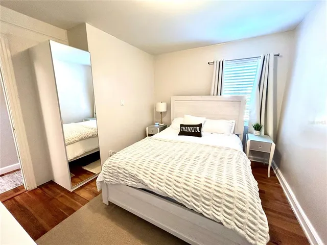 a bedroom with a bed and a large mirror