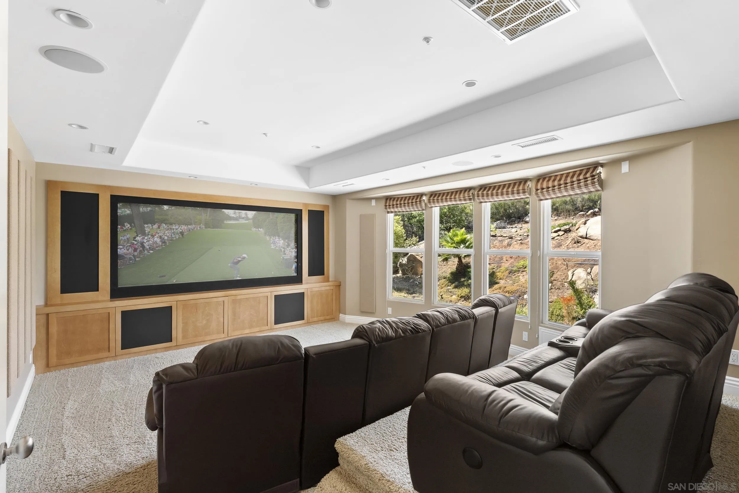 14998 Budwin Lane Poway, CA 92064 - Photo 23 of 44 a living room with furniture a large window with projector screen