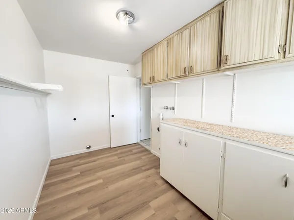 a view of a kitchen with white cabinets