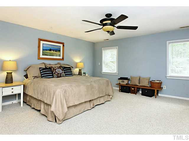 5504 Shimer Farm Lane Raleigh, NC 27614 - Photo 13 of 25 a bedroom with a bed and a chandelier