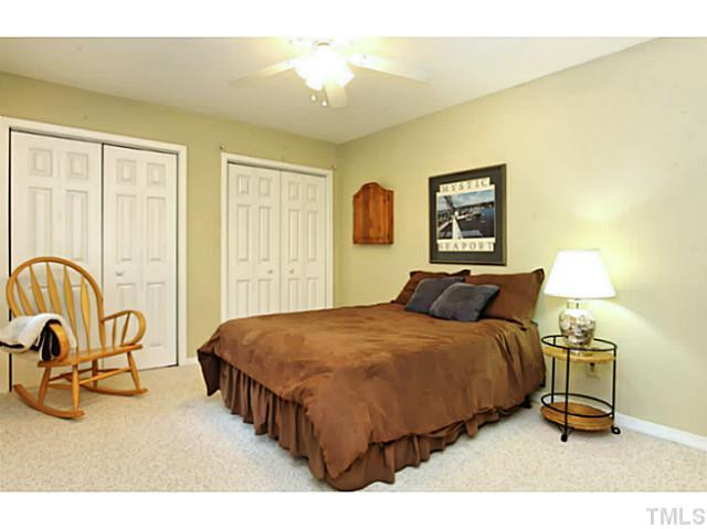 5504 Shimer Farm Lane Raleigh, NC 27614 - Photo 17 of 25 a bedroom with a bed and a table