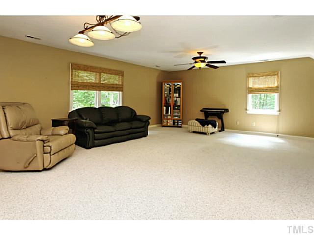 5504 Shimer Farm Lane Raleigh, NC 27614 - Photo 19 of 25 a living room with furniture a couch and a chandelier