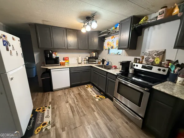a kitchen with sink cabinets and stainless steel appliances