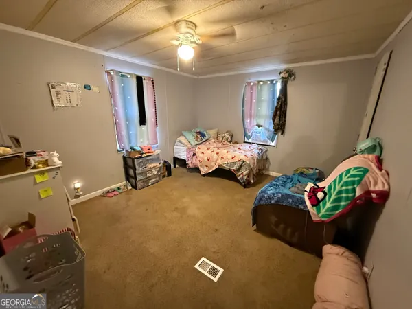 a bedroom with bed and window