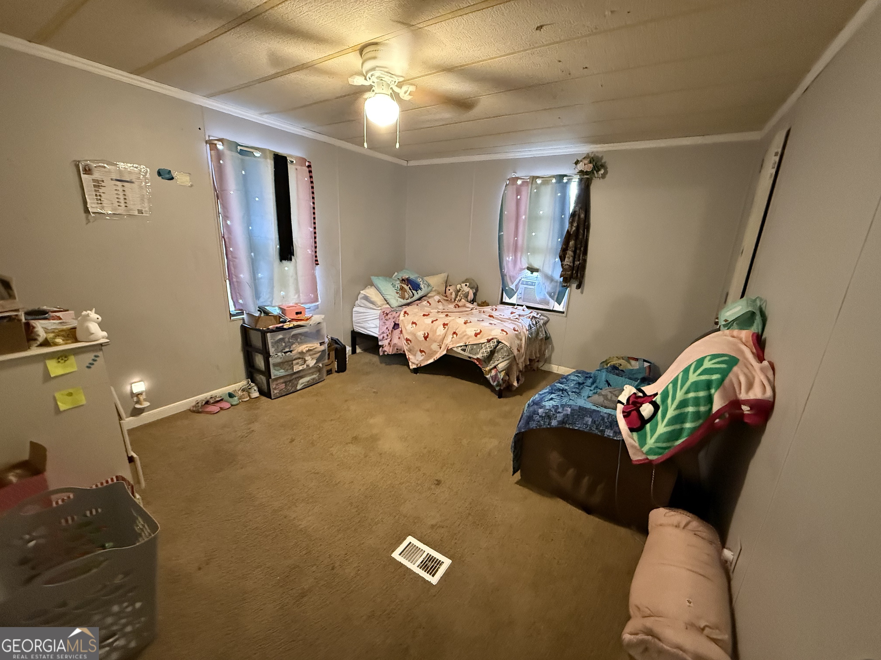 1775-1779 Payne Road Rentz, GA 31075 - Photo 28 of 51 a bed sitting in a bedroom next to a window