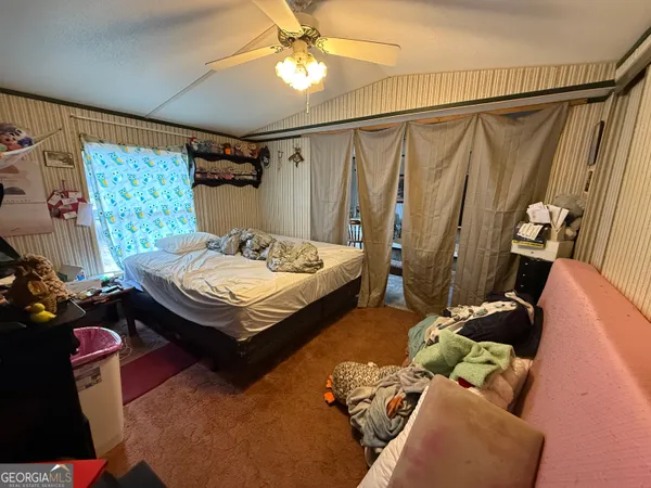 a room with lots of furniture and white walls