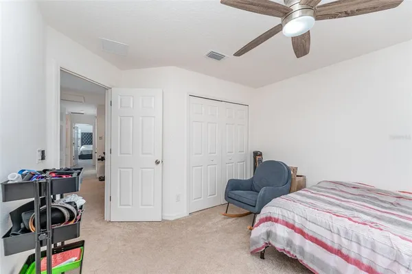 a bedroom with bed and a chandelier