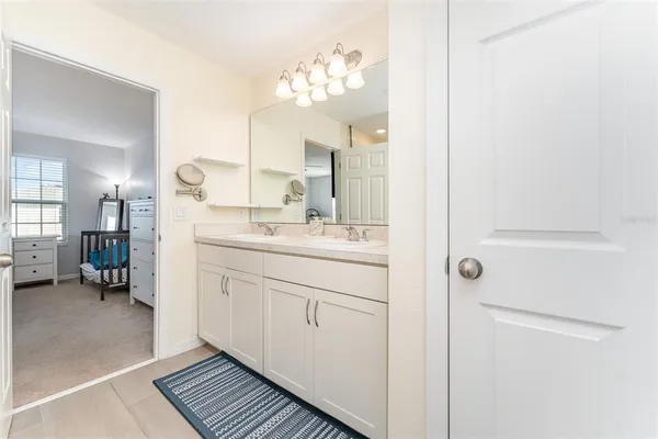 a bathroom with a sink vanity and a mirror