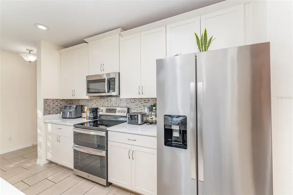 a kitchen with stainless steel appliances a refrigerator sink and stove
