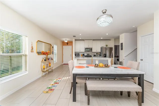 a kitchen with a refrigerator and a table