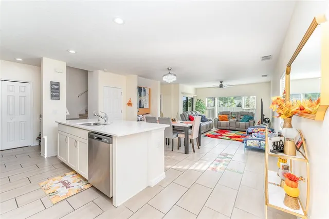 a kitchen with stainless steel appliances granite countertop a sink and a refrigerator