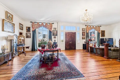a living room with furniture or couch and a chandelier