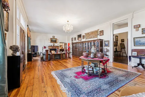 a dining hall with stainless steel appliances granite countertop a sink and cabinets