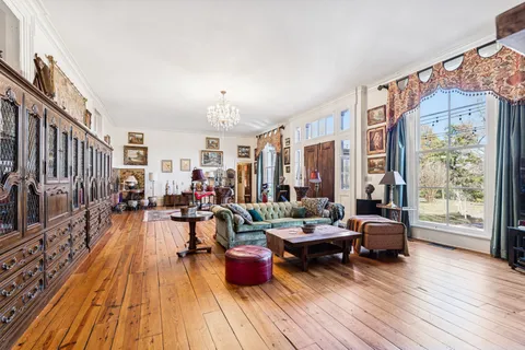 a living room with furniture a fireplace and next to a window