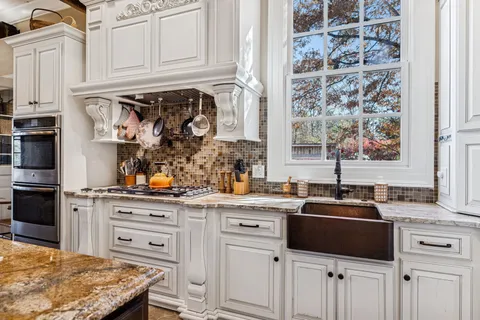 a spacious bathroom with a double vanity sink a mirror a bathtub and a shower