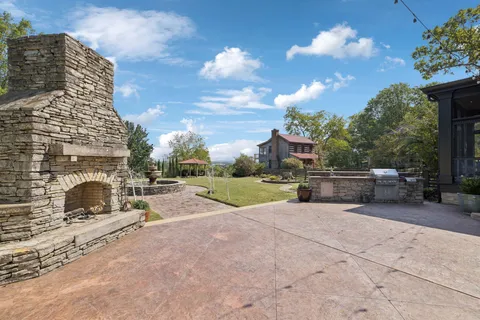 an aerial view of a house with a yard lake lake view and mountain view