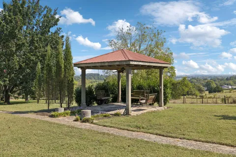 an aerial view of residential houses with outdoor space and trees