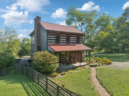 a view of a green field with lots of bushes