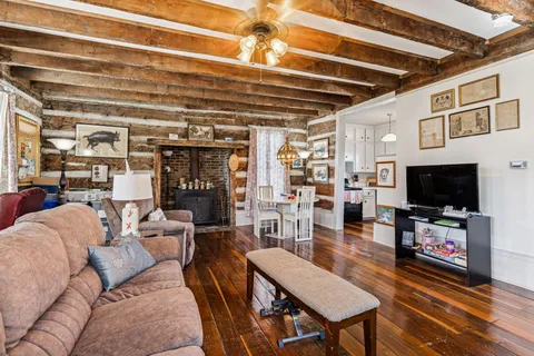 an aerial view of residential houses with outdoor space and trees