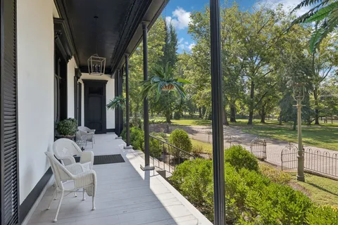 a living room with furniture and a book shelf