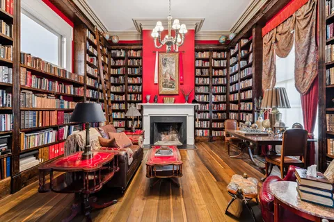 a living room with furniture book shelf and a book shelf