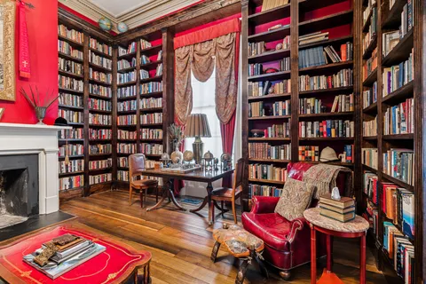 a living room with fireplace furniture and a window