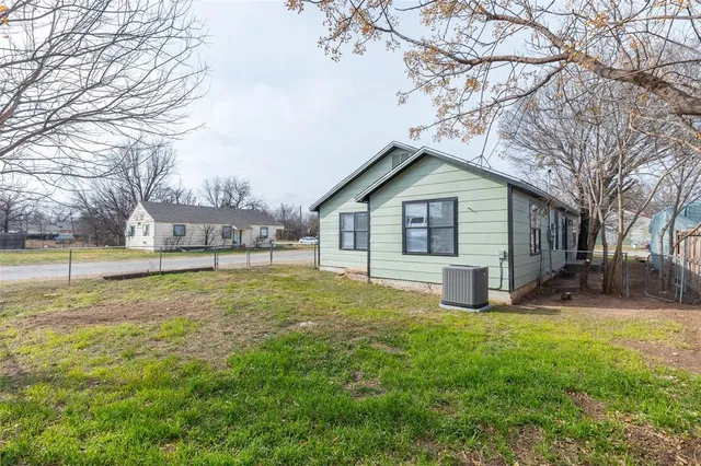 a view of a house with a yard and sitting area