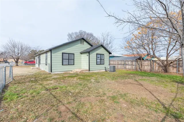 a view of a house with a yard and garage