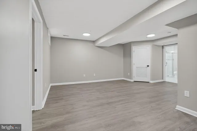 a view of an empty room with wooden floor