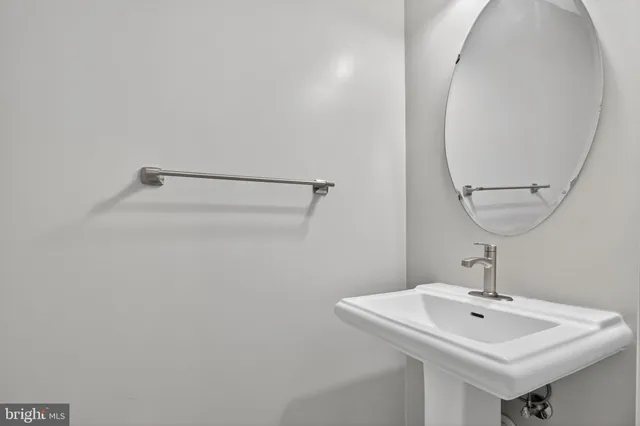 a bathroom with a sink and mirror