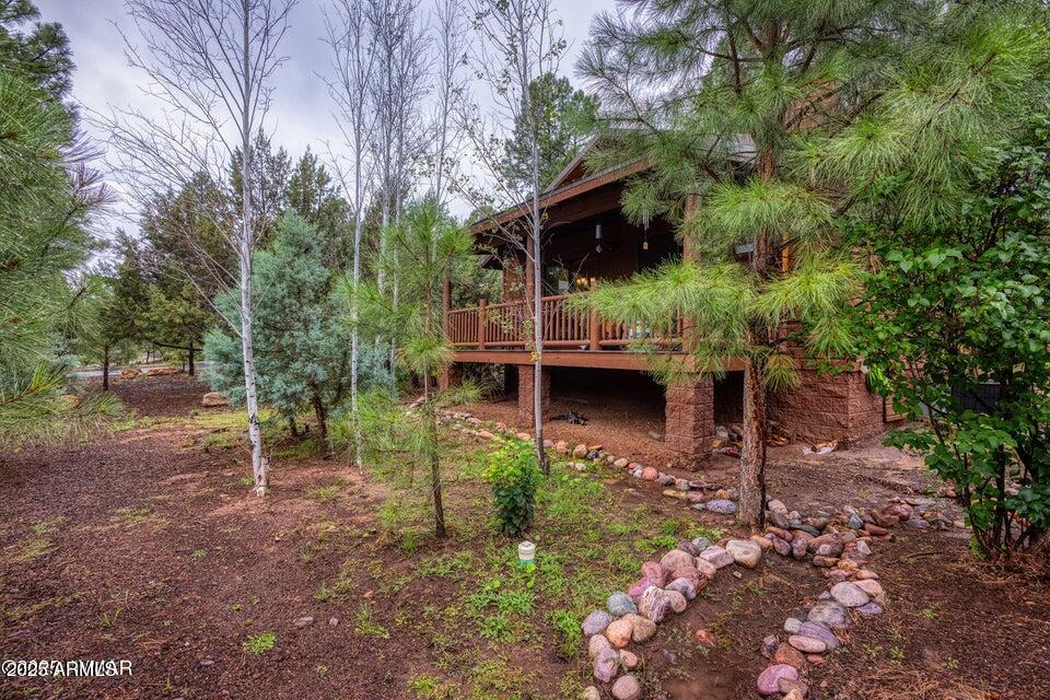 4800 West Tatanka Loop Show Low, AZ 85901 - Photo 1 of 36 a backyard of a house with lots of green space