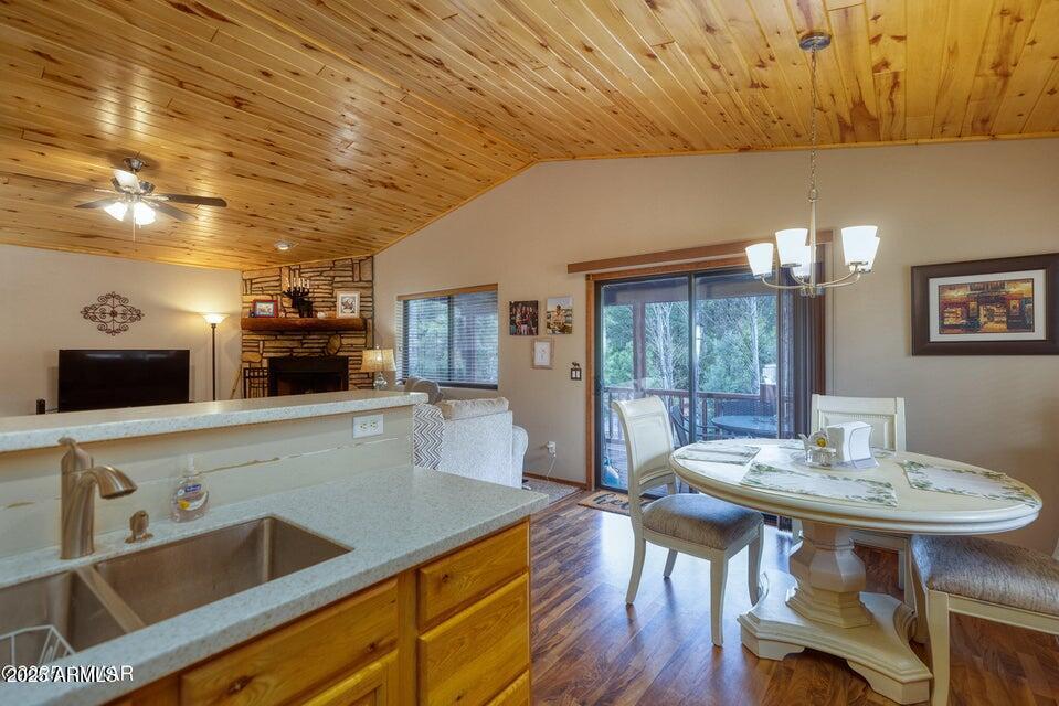 4800 West Tatanka Loop Show Low, AZ 85901 - Photo 13 of 36 a kitchen with a table chairs and wooden floor