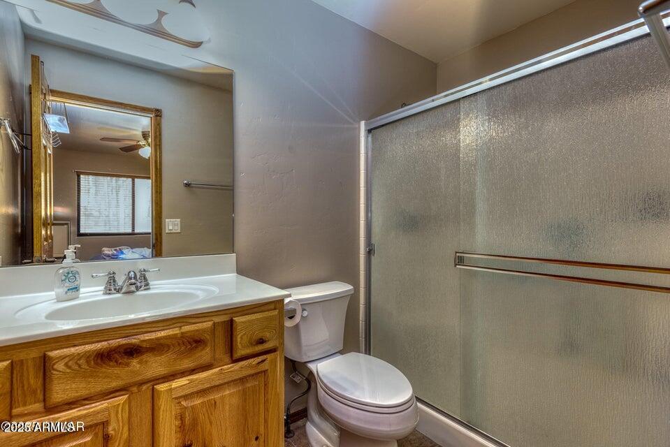 4800 West Tatanka Loop Show Low, AZ 85901 - Photo 17 of 36 a bathroom with a granite countertop sink toilet and shower