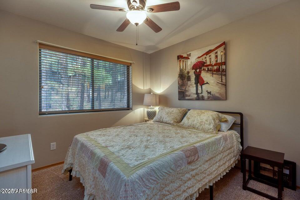 4800 West Tatanka Loop Show Low, AZ 85901 - Photo 18 of 36 a bedroom with a bed and a window