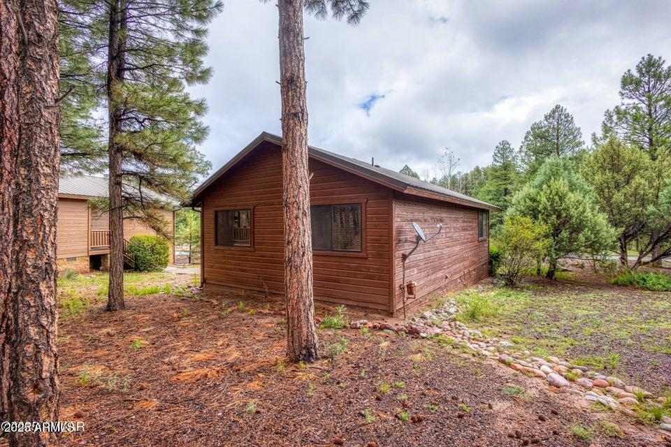 4800 West Tatanka Loop Show Low, AZ 85901 - Photo 23 of 36 a backyard of a house with barbeque oven table and chairs
