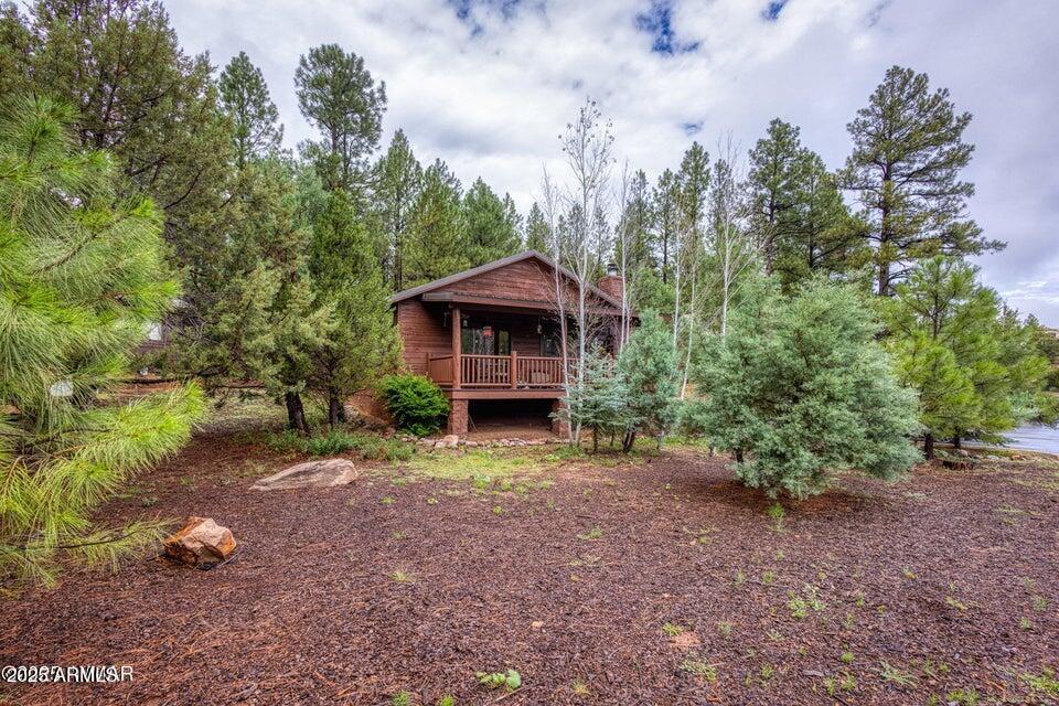 4800 West Tatanka Loop Show Low, AZ 85901 - Photo 3 of 36 a view of a house with a yard and tree s