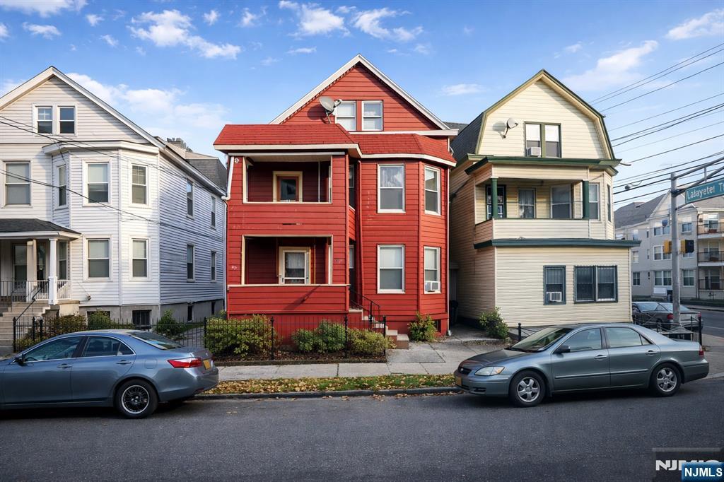 87 Rosa Parks Boulevard Paterson, NJ 07524 - Photo 1 of 6 a car parked in front of a house