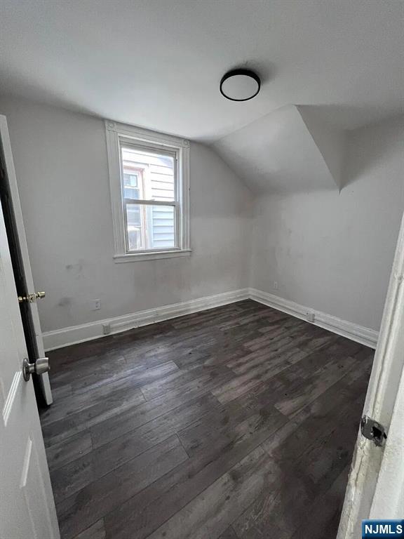 87 Rosa Parks Boulevard Paterson, NJ 07524 - Photo 3 of 6 an empty room with wooden floor and windows