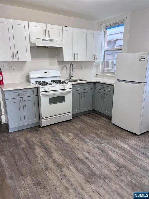 87 Rosa Parks Boulevard Paterson, NJ 07524 - Photo 5 of 6 a kitchen with a white cabinets and white appliances