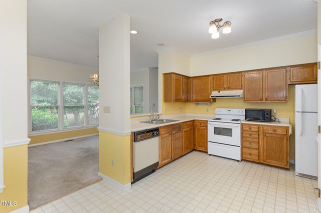 a kitchen with stainless steel appliances granite countertop a stove and a refrigerator