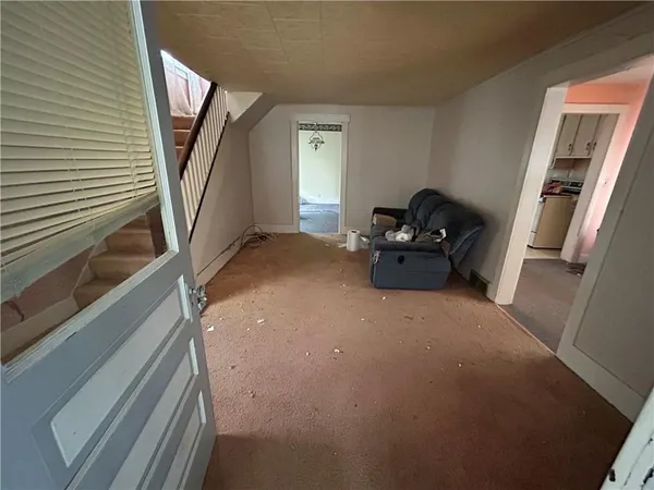 a hallway with couch and stairs