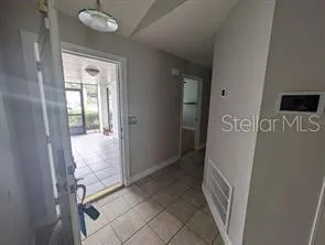 a kitchen with granite countertop a stove a sink and a refrigerator