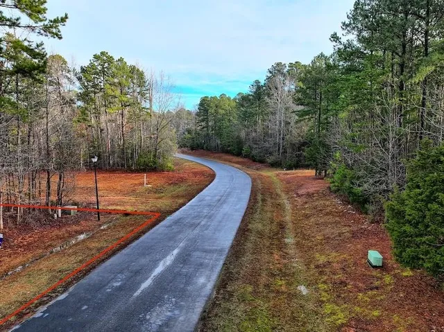a street sign on a sidewalk next to a road