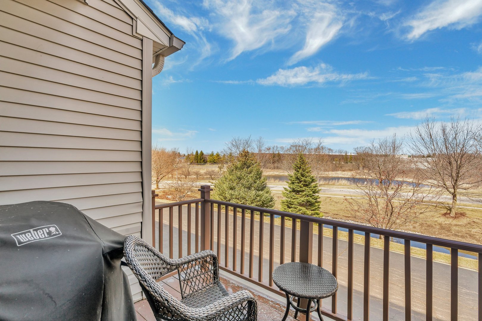 122 Enclave Circle, Unit D Bolingbrook, IL 60440 - Photo 19 of 20 a view of a balcony with chair and wooden floor