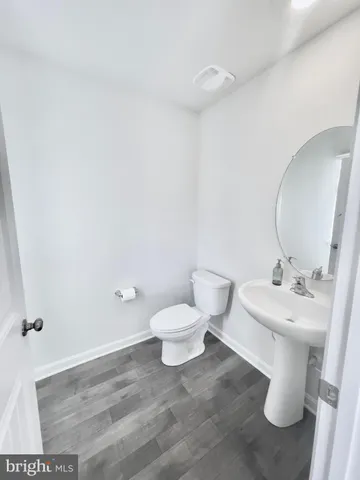 a white toilet sitting next to a bathroom sink