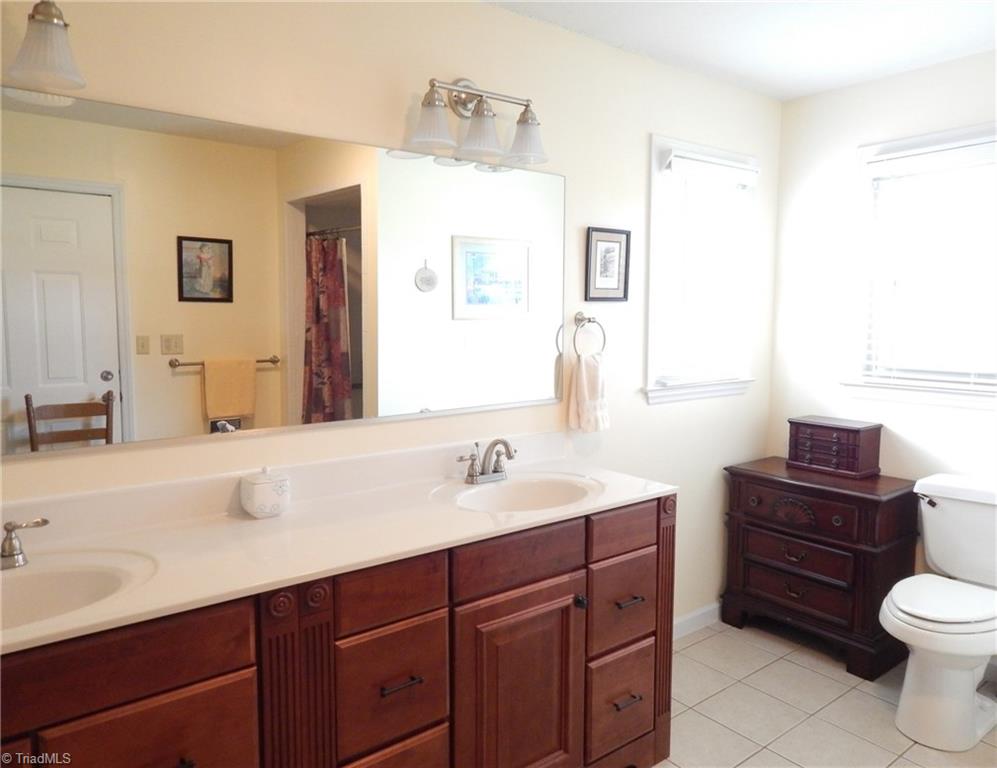 2103 Collinstown Road Westfield, NC 27053 - Photo 11 of 30 Gorgeous master suite with double vanity, tile flooring, and shower! Double corner windows allows the natural light in!!!