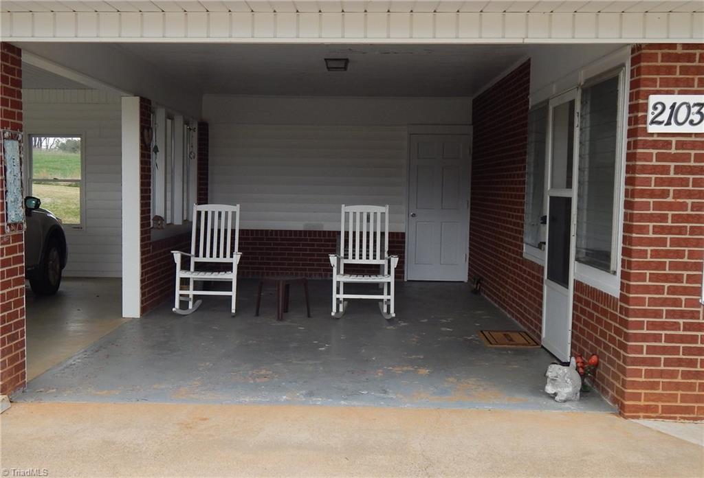 2103 Collinstown Road Westfield, NC 27053 - Photo 20 of 30 Currently this carport area is being used for relaxation, the door in the back leads into a 13' x 12' storage room!!